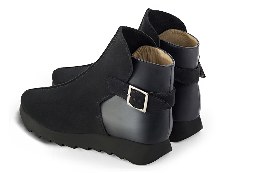 Matt black women's ankle boots with buckles at the back. Round toe. Low rubber soles. Rear view - Florence KOOIJMAN